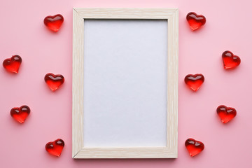 Empty frame and hearts on a pink pastel background. March 8, February 14, Valentine's Day card, Women's Day, holiday concept.