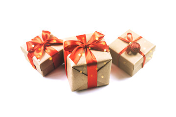 Festive gift boxes with red ribbon bow isolated on white background.