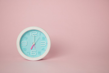 white clock on pink background