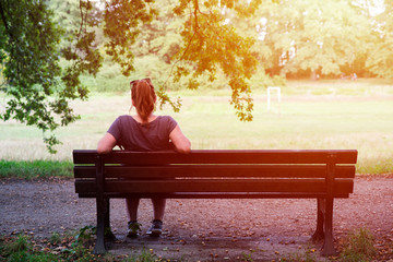 close up on lonely woman on the bench