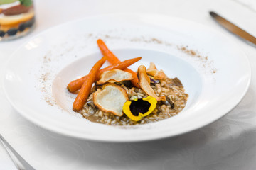 vegan gluten-free risotto with wild mushrooms, glazed carrots, parsley chips and forest powder