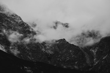 heavy clouds on the sharp Tatra mountain, black and white with noise