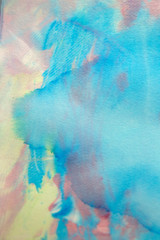 This is a photograph of a Blue, Pink and Yellow abstract background created using watercolours