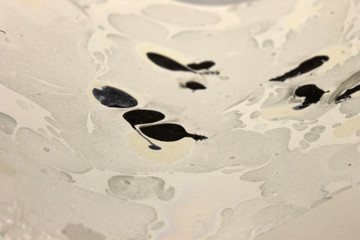 This is a photograph of a Black, Gray and White abstract background created using nail polish