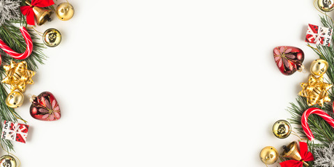 Christmas frame on a white background. Fir branches with Christmas decorations and gifts.