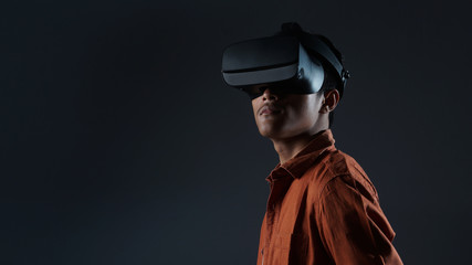close up young man wearing vr glasses isolated on black