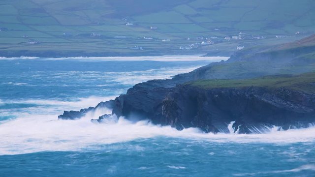 footage of the coast of south west ireland on the ring of kerry showing waves battering the shoreline during a storm and the skellig islands, a filming location of the star wars movies