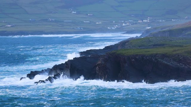footage of the coast of south west ireland on the ring of kerry showing waves battering the shoreline during a storm and the skellig islands, a filming location of the star wars movies