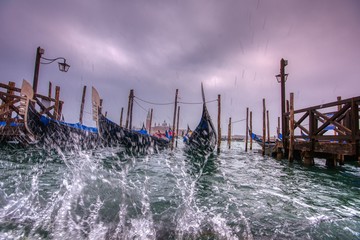 Gondolas parked at San Marco square with high tide.