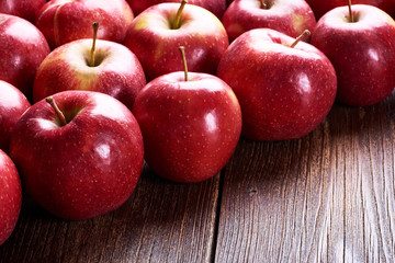 Still life with red apples on old wooden board table