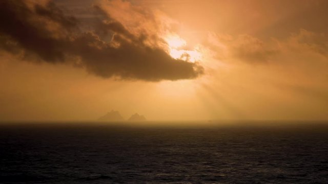 footage of the coast of south west ireland on the ring of kerry showing waves battering the shoreline during a storm and the skellig islands, a filming location of the star wars movies