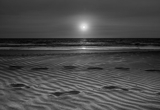 black and white or monochrome landscape of Pollem beach with footprints, Goa, India
