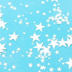 Light blue background with many shiny stars.