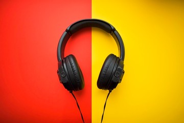 Black headphones on a red and yellow background