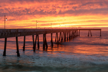 Fototapeta na wymiar Fiery Sunset over Pacifica Municipal Pier. Pacifica, San Mateo County, California, USA.