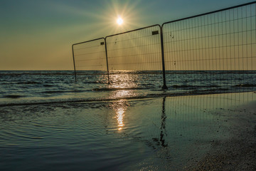 Temporary still fenced beach, Beach closed for the public concept.