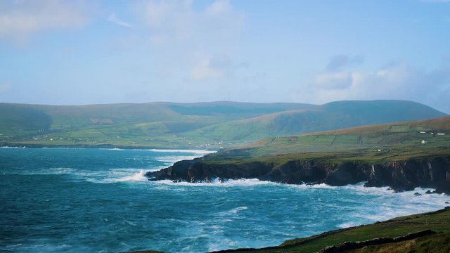footage of the coast of south west ireland on the ring of kerry showing waves battering the shoreline during a storm and the skellig islands, a filming location of the star wars movies