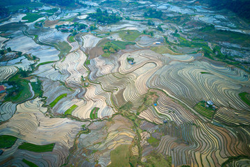 Fototapeta na wymiar Aerial image of great rice terraces in Y Ty, Lao Cai, Vietnam in watering season (from May to June every year)