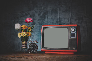 Old retro TV are still life with clocks and flower vases.