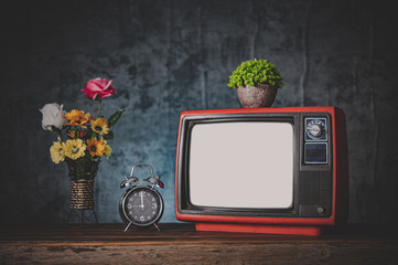 Old retro TV are still life with clocks and flower vases.