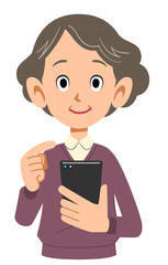 携帯電話を操作するシニアの女性