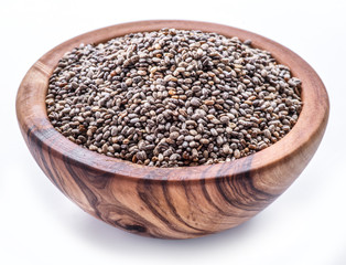 Chia seeds in wooden bowl isolated on white background.