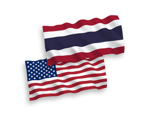 National vector fabric wave flags of Thailand and USA isolated on white background. 1 to 2 proportion.