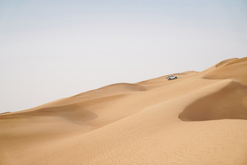 4x4 Off-road vehicle adventure in scenic view of dessert sand dunes 