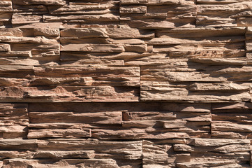 Abstract beige brown slate pattern stone block wall texture for background and wallpaper large and wide modern stone wall facade