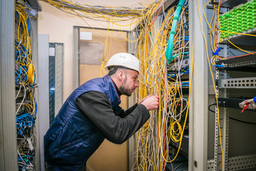  Engineer in white helmet repair broken internet connection. Professional internet campaign for a...