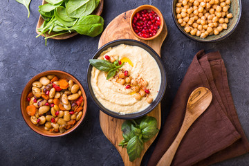 Mediterranean mezze board with  hummus, beans, spinach . top view