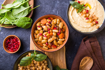 cooked kidney beans, white beans, chickpeas and homemade hummus  on a plate, stone background. yop...