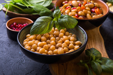 cooked kidney beans, white beans, chickpeas and homemade hummus  on a plate, stone background. yop view