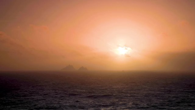 footage of the coast of south west ireland on the ring of kerry showing waves battering the shoreline during a storm and the skellig islands, a filming location of the star wars movies