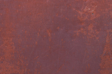 Fine texture of a rusty metal surface once painted red