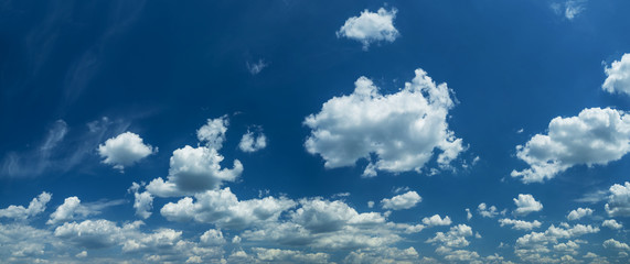 Some light cumuliform clouds in the clean blue sky.