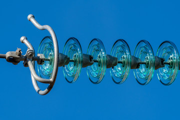 Transparent high voltage isolator against a blue sky