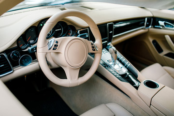 Wide view of modern car interior with light-colored decoration