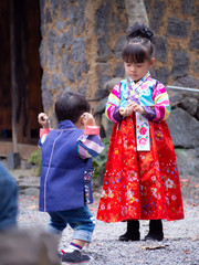 Aasian little boy and  girl wearing a Korean Traditional Hanbok dress  at Ancient village