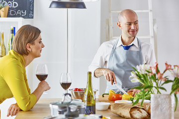 Smiling young couple cooking food in the kitchen