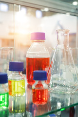 Chemical glassware. Flasks, vials, bottles. Bottles filled with colored liquid.