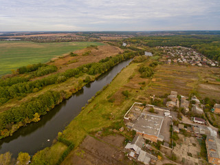 European village, river, forest. Aerial view.