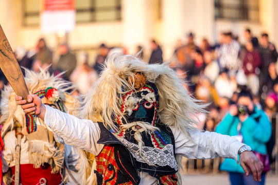 Mummers perform rituals to scare evil spirits at Surva festival at Pernik in Bulgaria. The people with the masks are called Kuker (kukeri). Wool mask and wood sword.