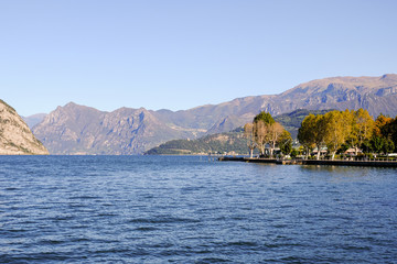 Landscape of Iseo Lake. Alpine lake during a sunny day with a blue sky.