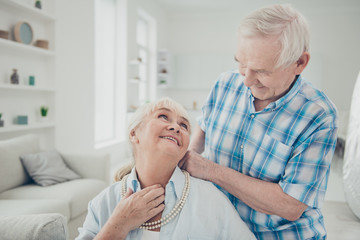 Photo of two adorable aged people pair spending time together holiday surprise pearls necklace comfortable flat indoors