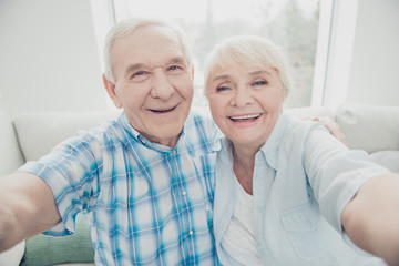 Self-portrait of two nice attractive lovely cheerful cheery positive glad confident people life partners peaceful lifestyle in light white interior house