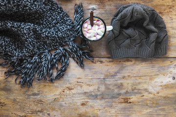 Scarf and hat near hot chocolate