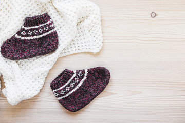 Knitted socks near blanket