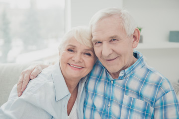 Close-up portrait of her she his he two nice attractive charming lovely sweet tender gentle cheerful peaceful calm spouses hugging in light white interior room indoors