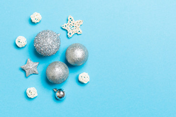 Creative set of New Year baubles and decorations on colorful background. Top view of Christmas time concept. Copy space